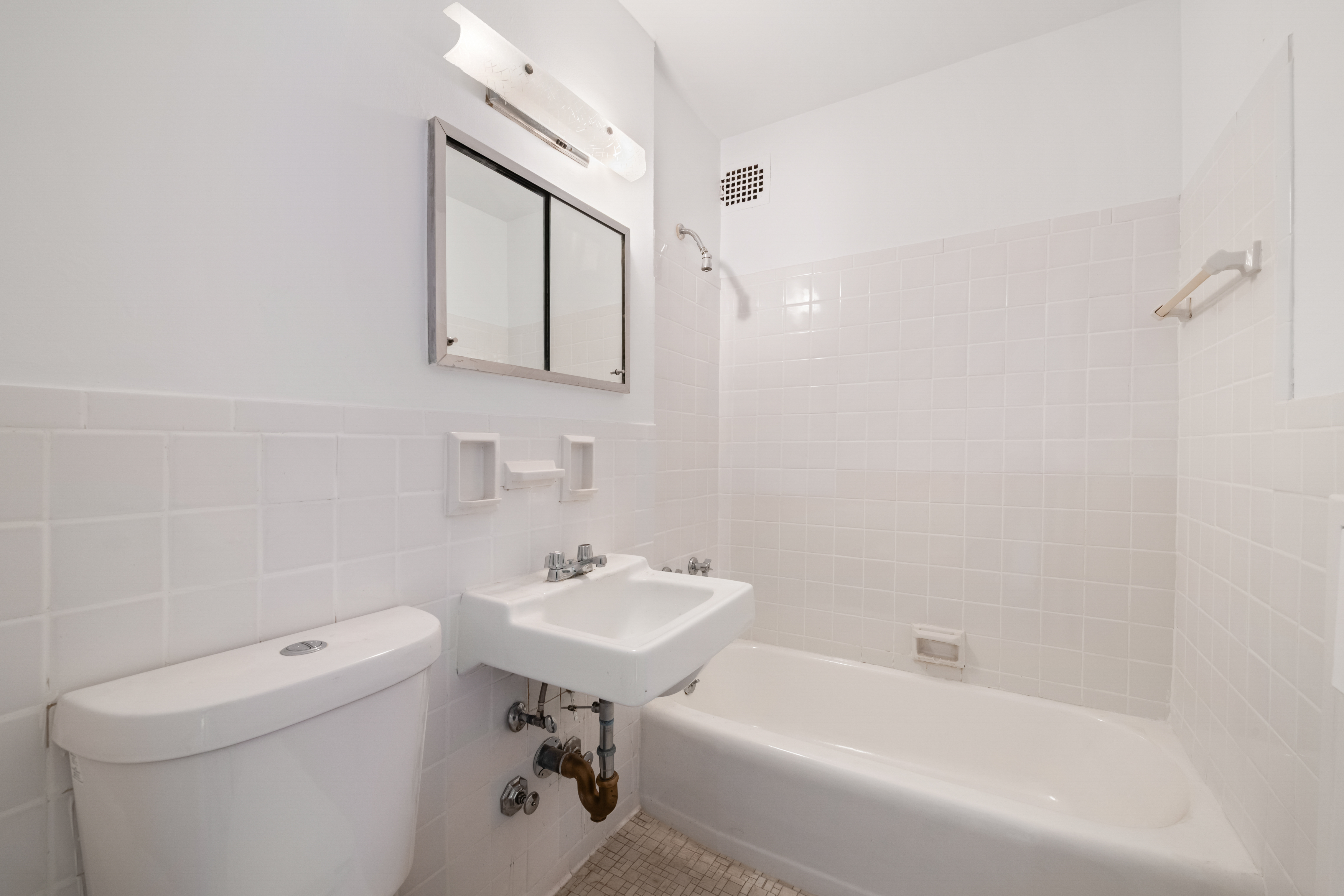 201 West 21st Street, Unit 9A Manhattan, NY 10011 - Photo 9 of 13 a bathroom with a sink a toilet and bathtub