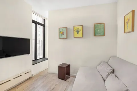 a bed room with a bed and a painting on the wall