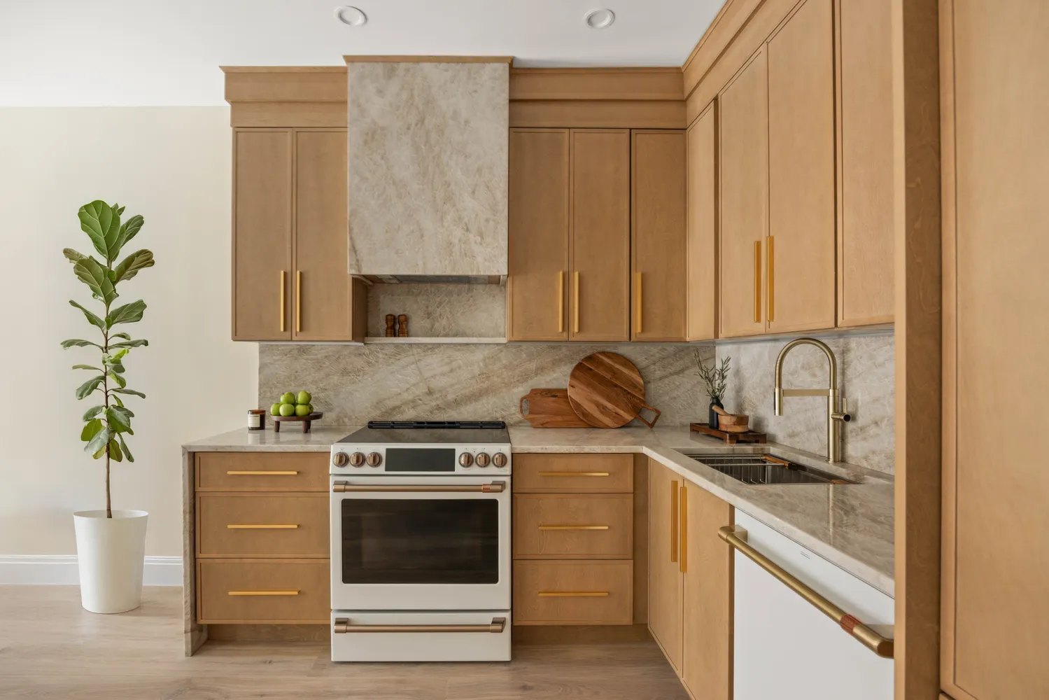 a kitchen with stainless steel appliances granite countertop a sink a stove and a window