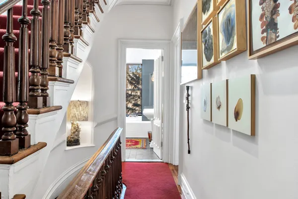 a view of hallway with furniture and a kitchen view