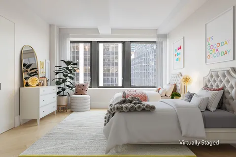 a bedroom with bed and a large window