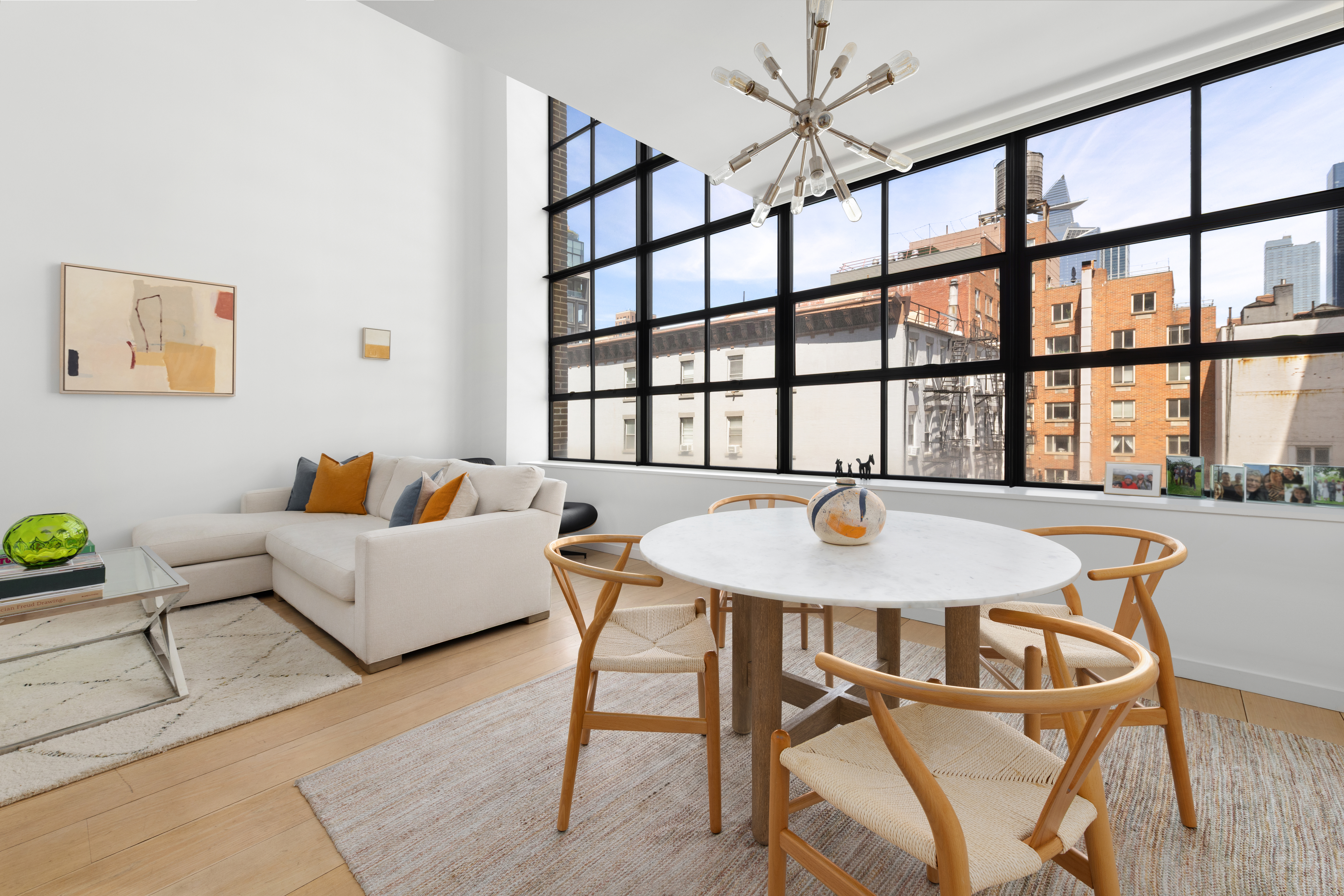 456 West 19th Street, Unit 4/5A Manhattan, NY 10011 - Photo 4 of 15 a living room with furniture and a large window