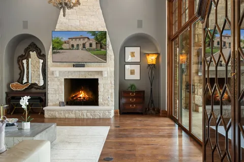 a very nice looking living room with a large window and dining table