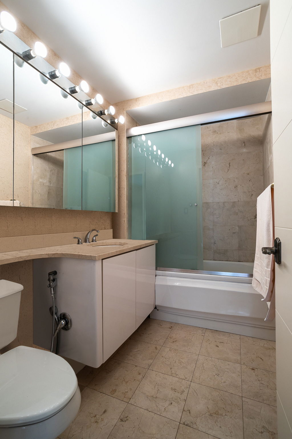 135 Oceana Drive East, Unit 2C Brooklyn, NY 11235 - Photo 12 of 29 a bathroom with a sink mirror vanity and toilet
