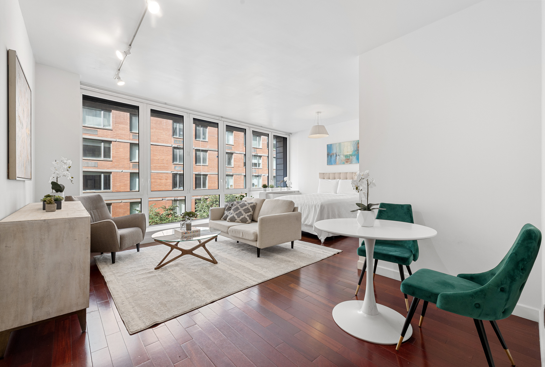 125 West 21st Street, Unit 4C Manhattan, NY 10011 - Photo 2 of 12 a living room with furniture and a large window
