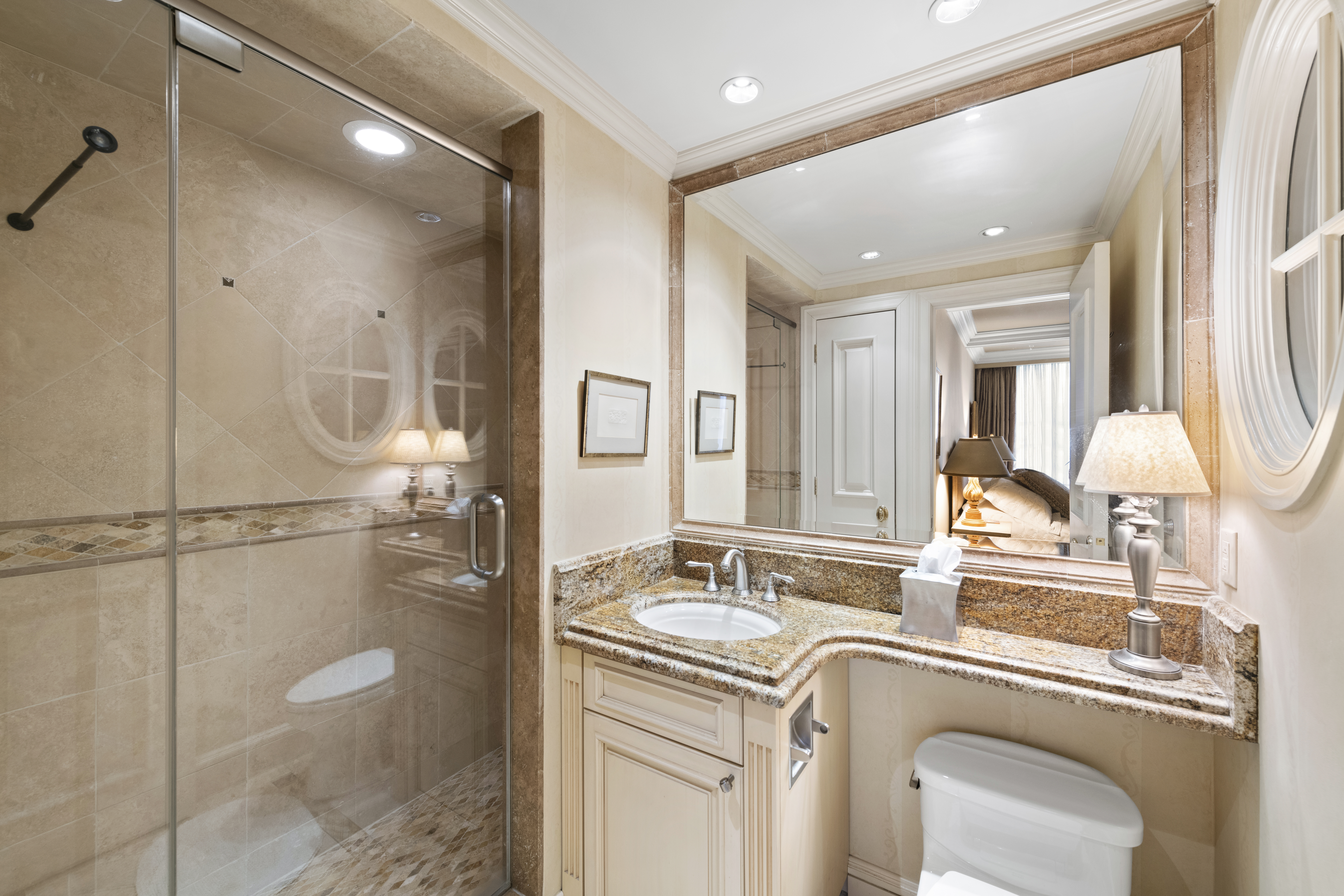 169 East 69th Street, Unit 7/8 B Manhattan, NY 10021 - Photo 17 of 30 a bathroom with a granite countertop sink a mirror and shower