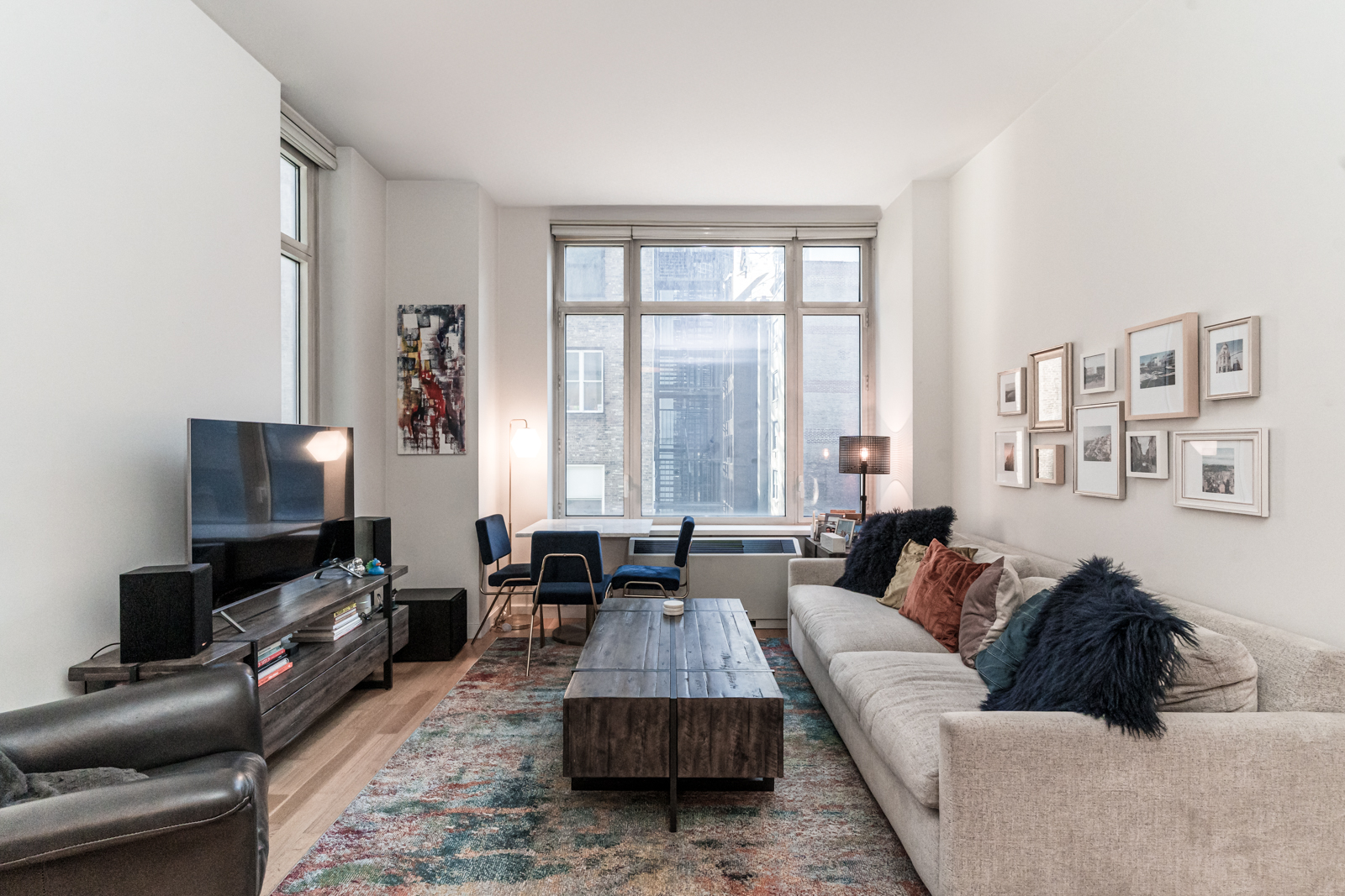 325 5th Avenue, Unit 14E Manhattan, NY 10016 - Photo 2 of 19 a living room with furniture and a flat screen tv