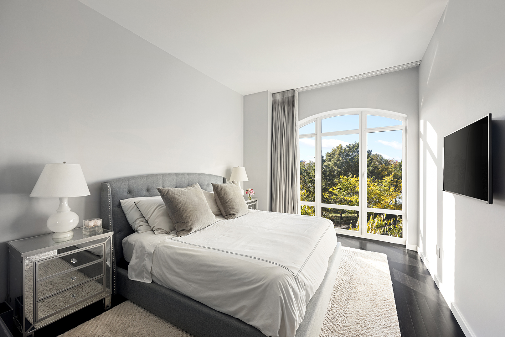 400 West 12th Street, Unit 4J Manhattan, NY 10014 - Photo 6 of 21 a bedroom with a bed and a large window