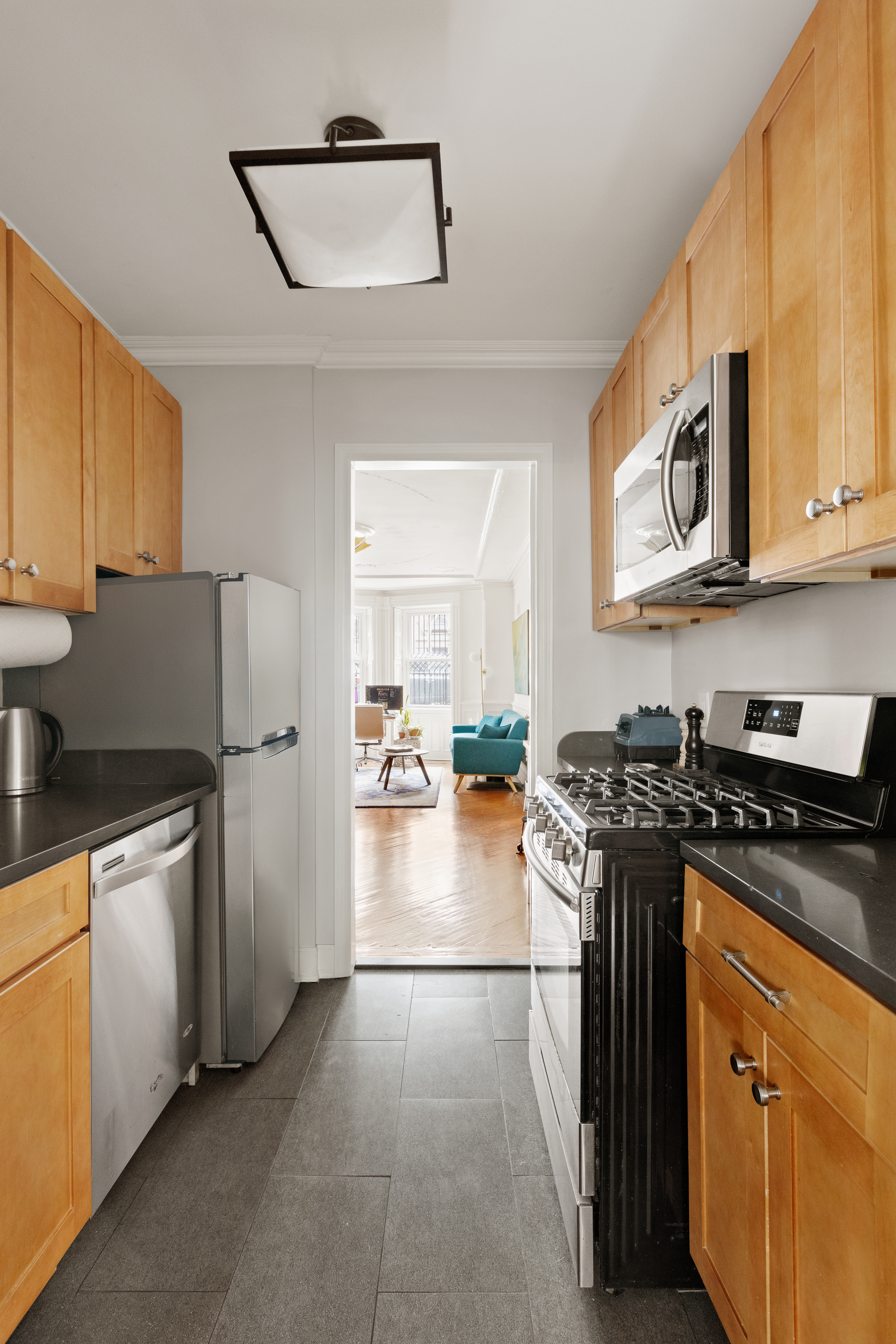 196 Berkeley Place Brooklyn, NY 11217 - Photo 21 of 25 a kitchen with stainless steel appliances granite countertop a stove top oven a sink a refrigerator and white cabinets