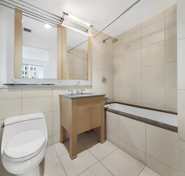 a bathroom with a sink a toilet and a mirror