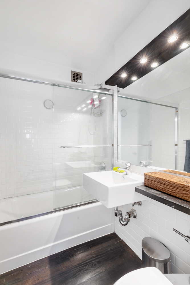 165 Christopher Street, Unit 3I Manhattan, NY 10014 - Photo 10 of 20 a bathroom with a sink a toilet and shower