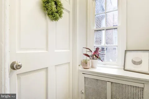 a bedroom with a bed and a potted plant