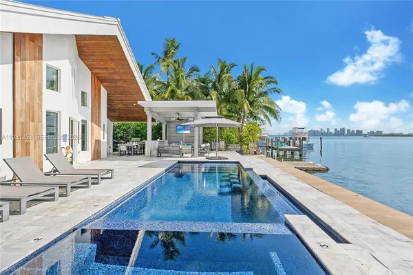 a view of a swimming pool with outdoor seating