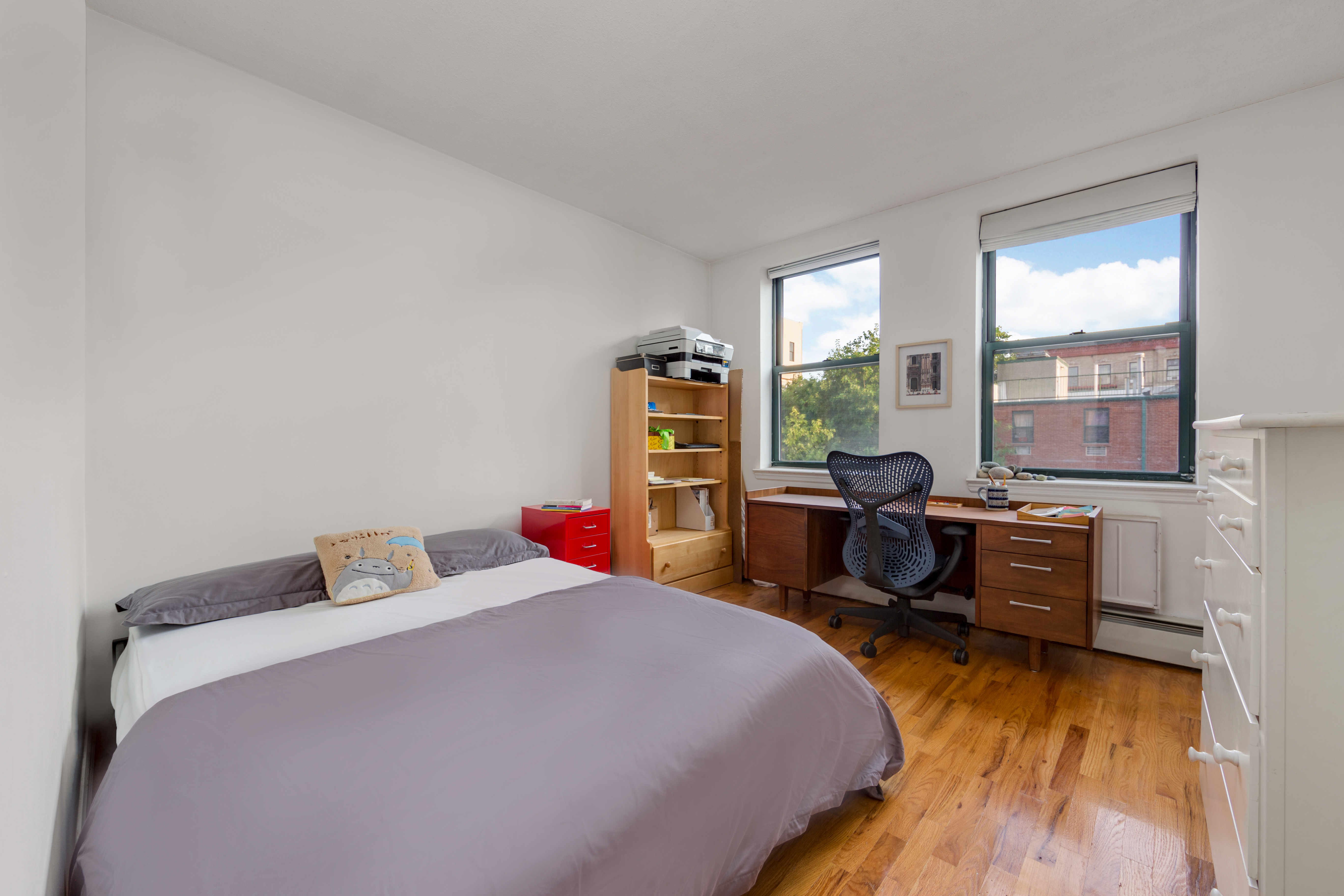 226 West 123rd Street, Unit 2 Manhattan, NY 10027 - Photo 5 of 9 a bedroom with a bed and wooden floor