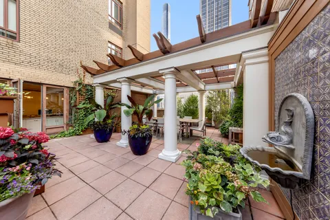 a view of a chairs and table in a patio