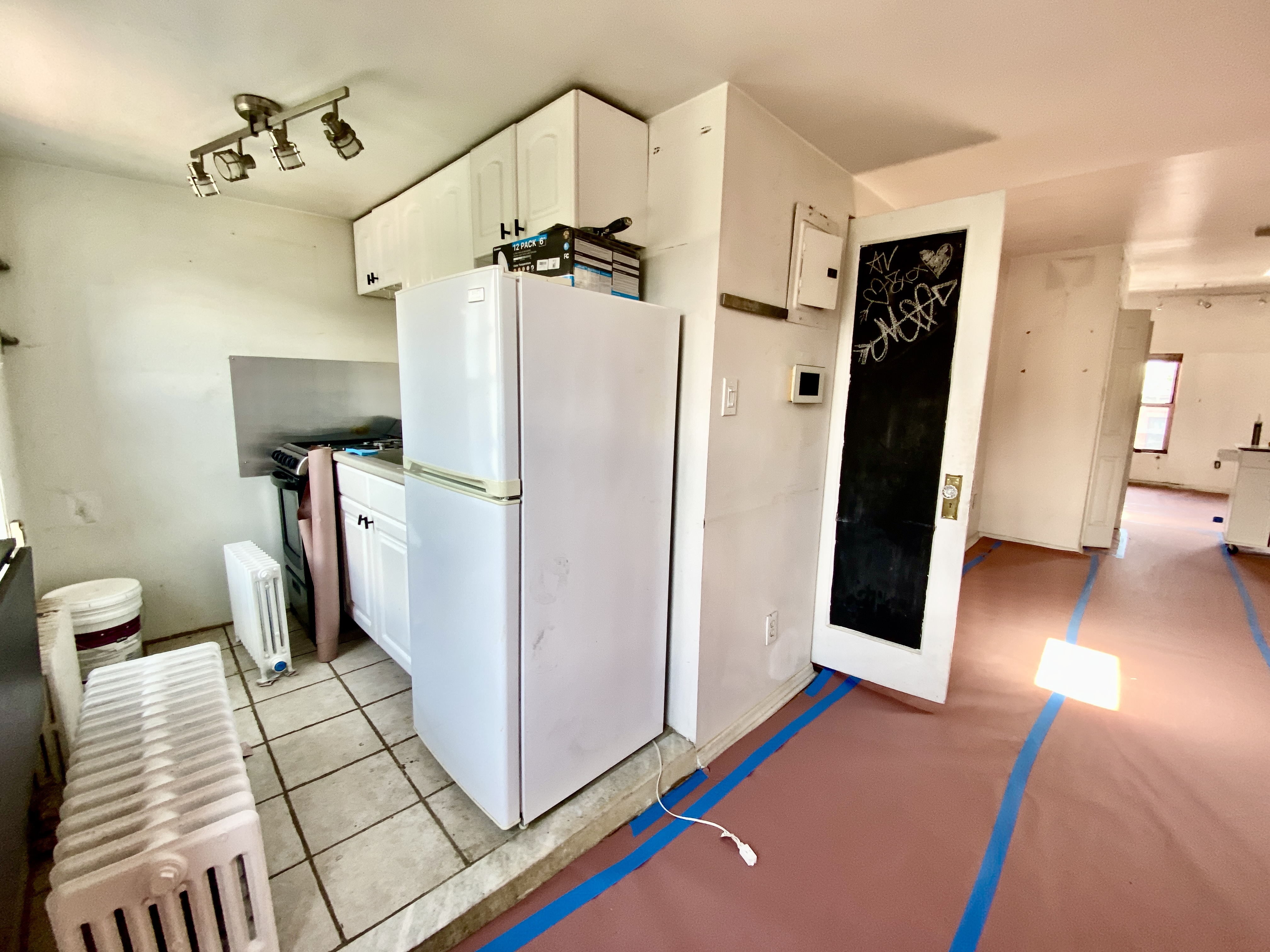 140 Washington Avenue, Unit 4 Brooklyn, NY 11205 - Photo 5 of 8 a view of a bedroom with baby crib and refrigerator