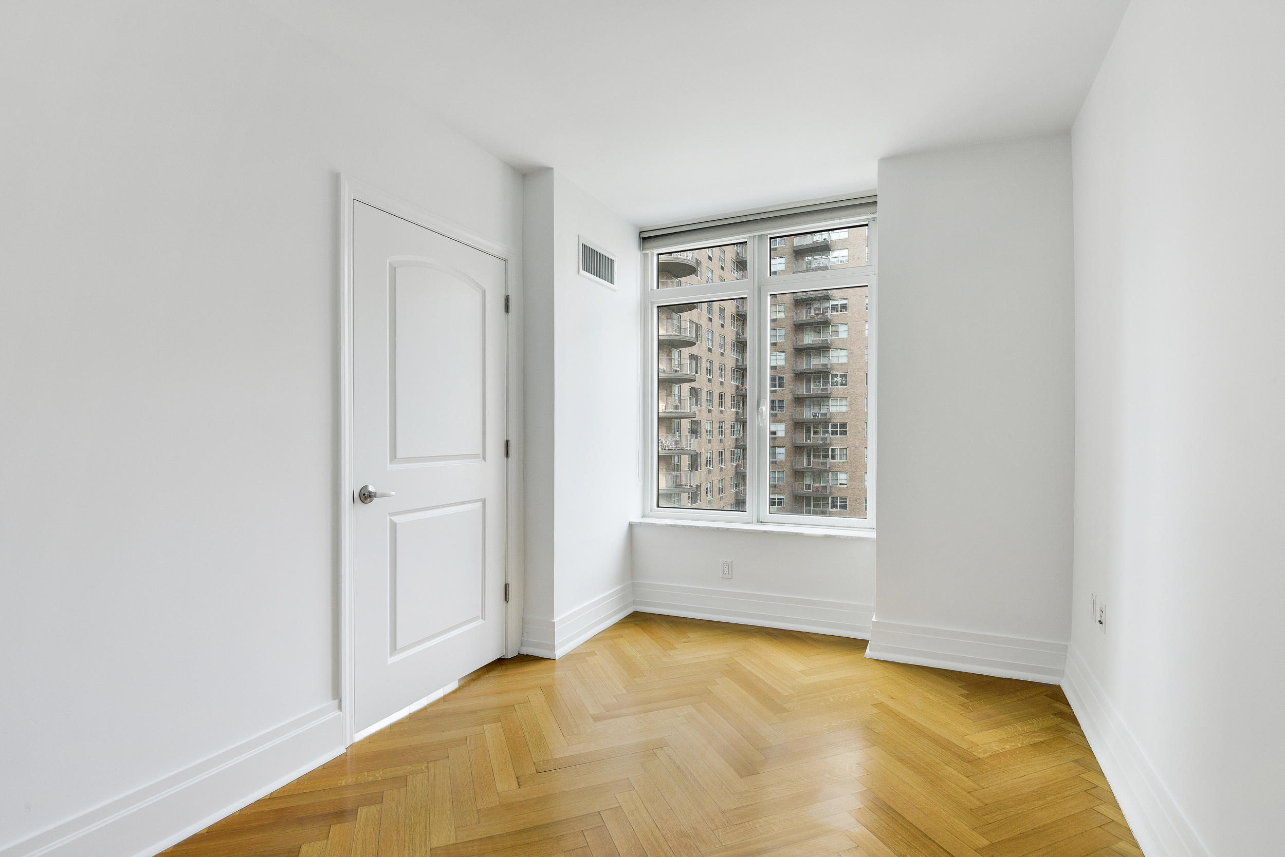 205 East 85th Street, Unit 12H Manhattan, NY 10028 - Photo 7 of 19 a view of an empty room with a window
