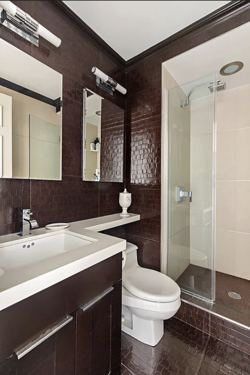 1441 3rd Avenue, Unit 14A Manhattan, NY 10028 - Photo 9 of 10 a bathroom with a sink a toilet a mirror and shower