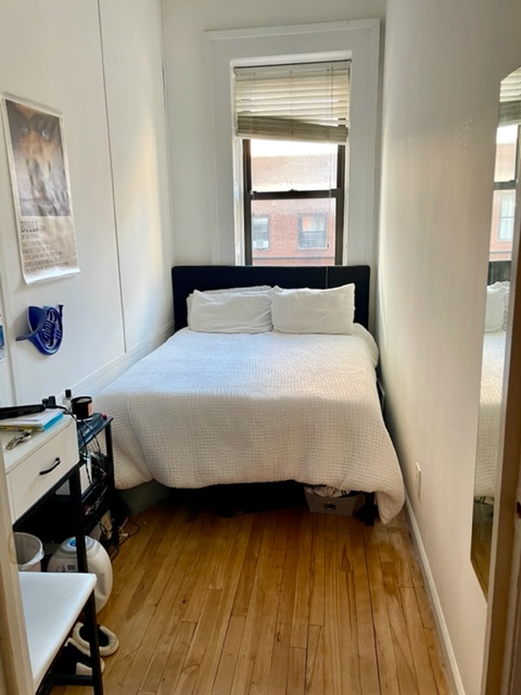 210 East 60th Street, Unit 4 Manhattan, NY 10022 - Photo 5 of 8 a bedroom with a bed and a window