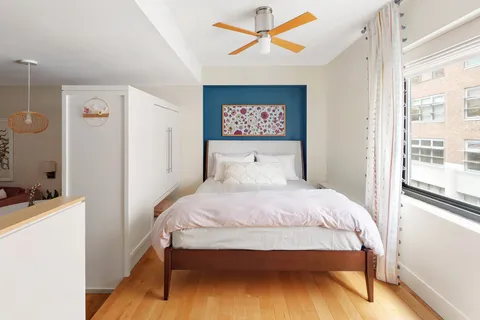 a bedroom with a bed and a window