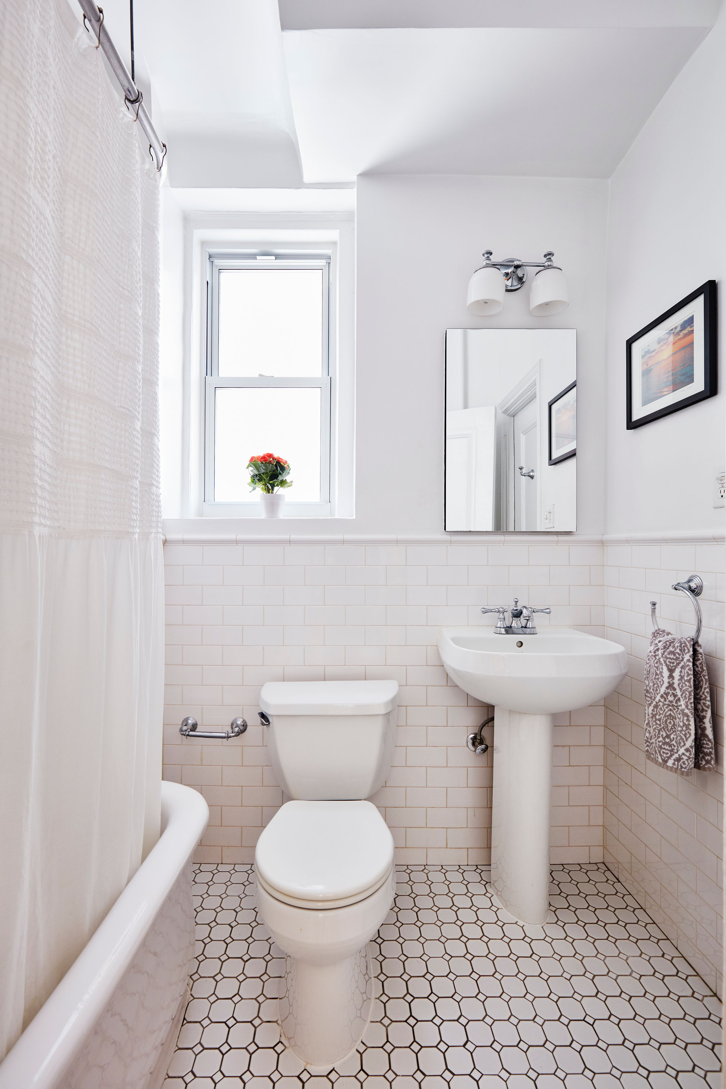 200 West 54th Street, Unit 4H Manhattan, NY 10019 - Photo 5 of 8 a bathroom with a sink toilet and mirror