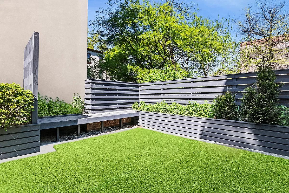 180 Bainbridge Street, Unit 305 Brooklyn, NY 11233 - Photo 11 of 23 a view of a back yard of the house with a bench