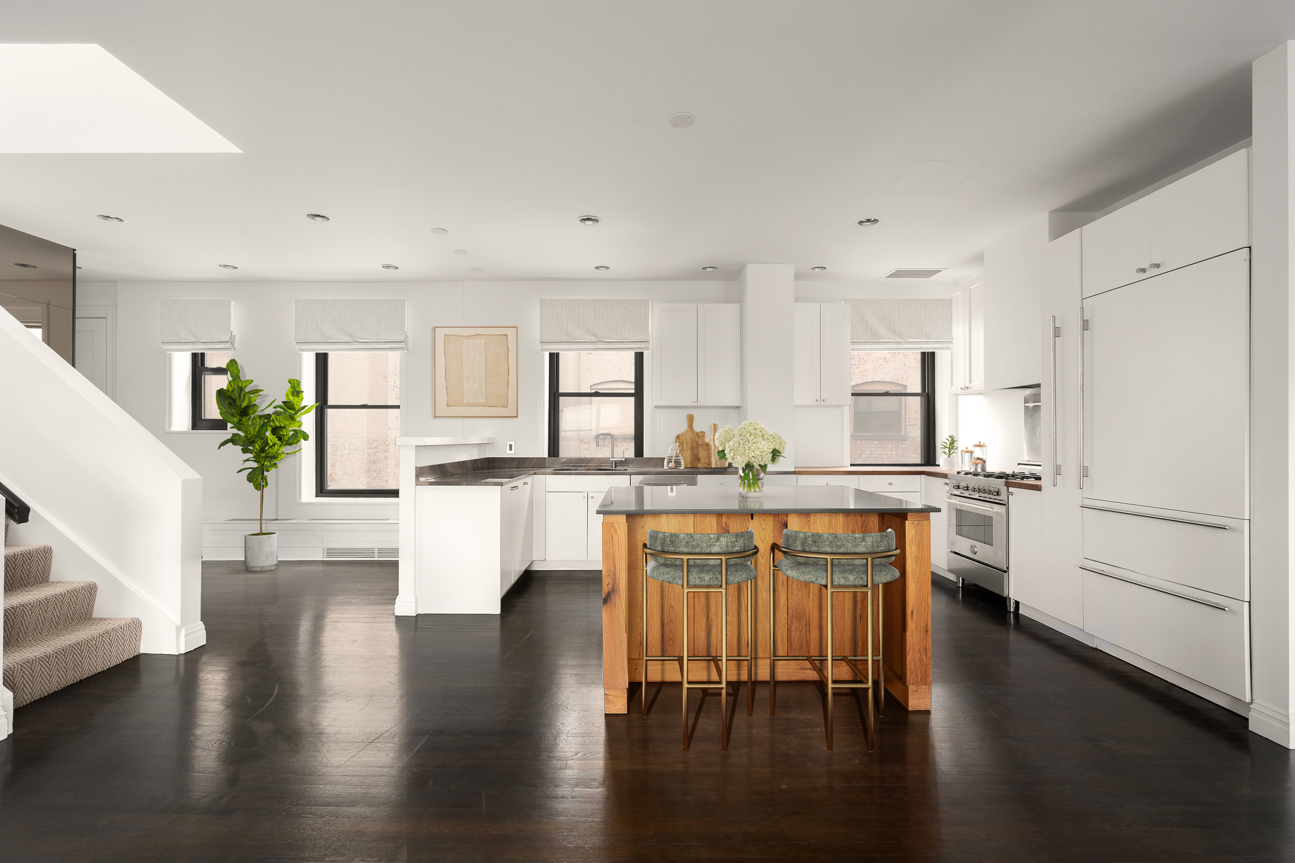 104 West 70th Street, Unit PH Manhattan, NY 10023 - Photo 4 of 17 a kitchen with kitchen island wooden floors white appliances and cabinets