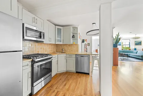 a kitchen with granite countertop stainless steel appliances and wooden cabinets