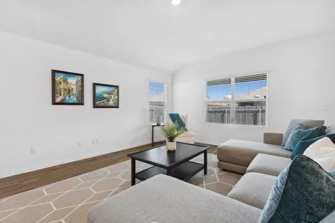 a living room with furniture and painting on the wall