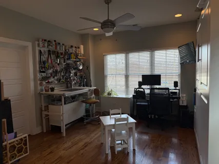 a view of a workspace with furniture and a window