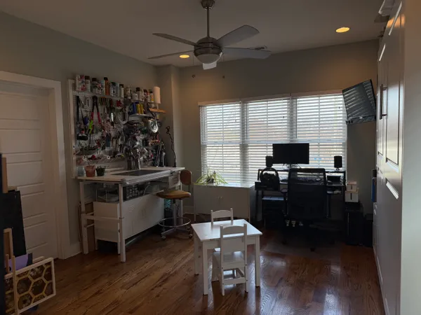 a view of a workspace with furniture and a window