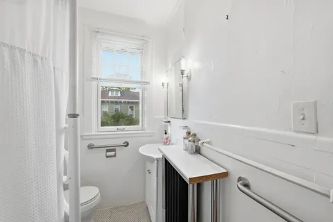 a bathroom with a sink a toilet and a mirror