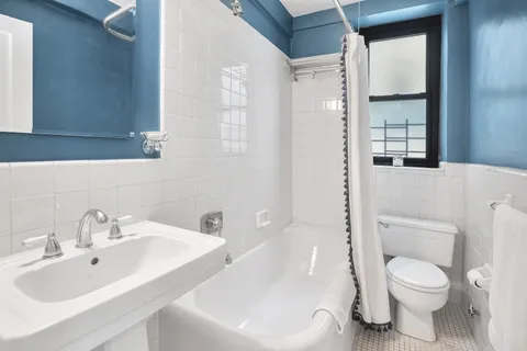 a white toilet sitting next to a bathroom sink