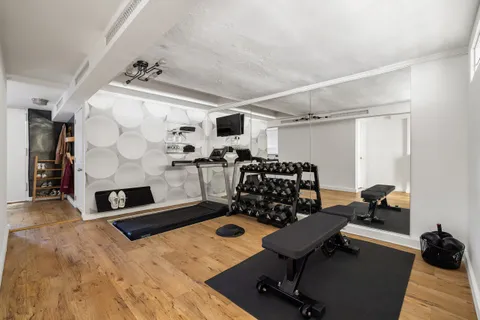 a room with gym equipment and a table