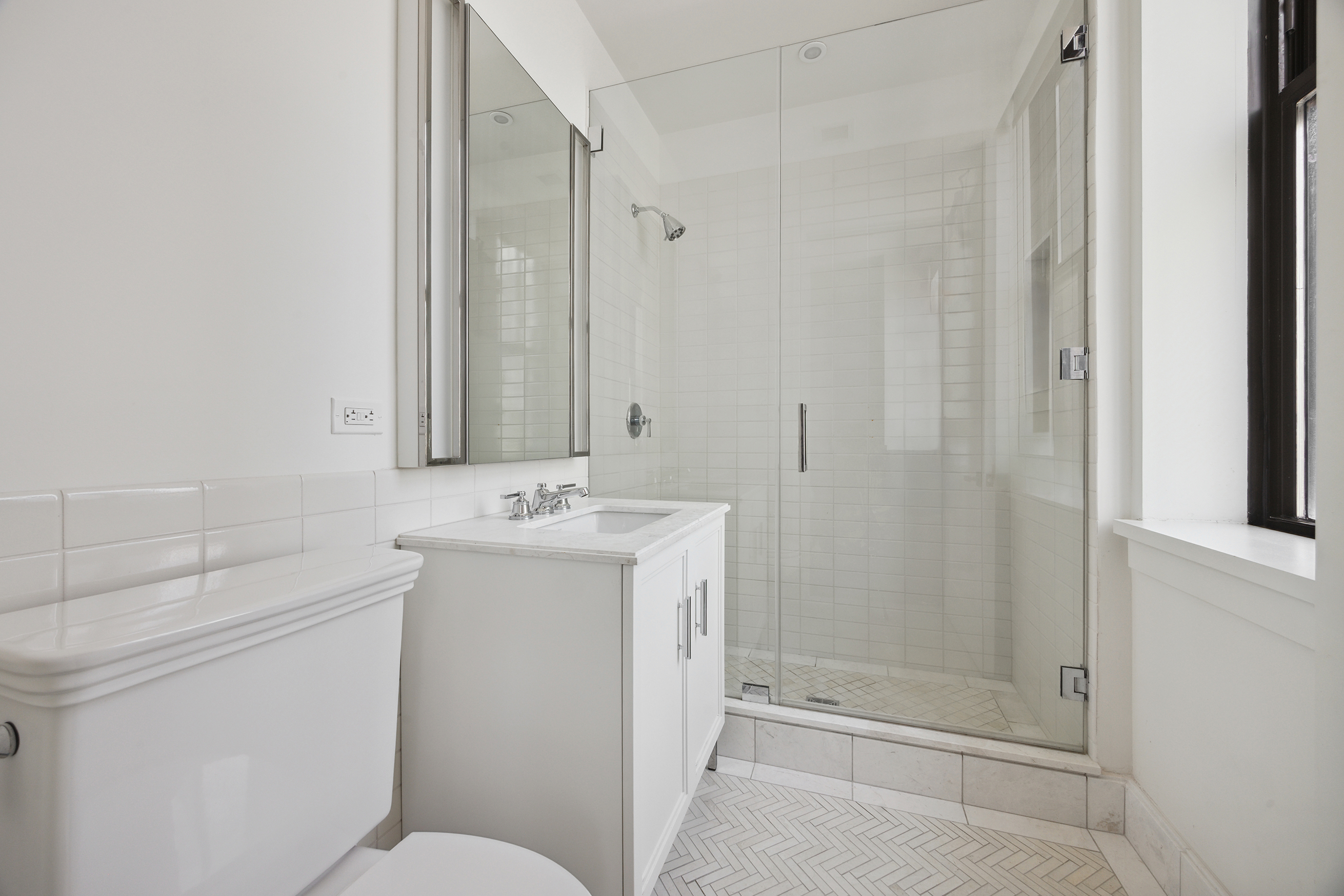 100 Barclay Street, Unit 15B Manhattan, NY 10007 - Photo 14 of 16 a bathroom with a sink a toilet and shower