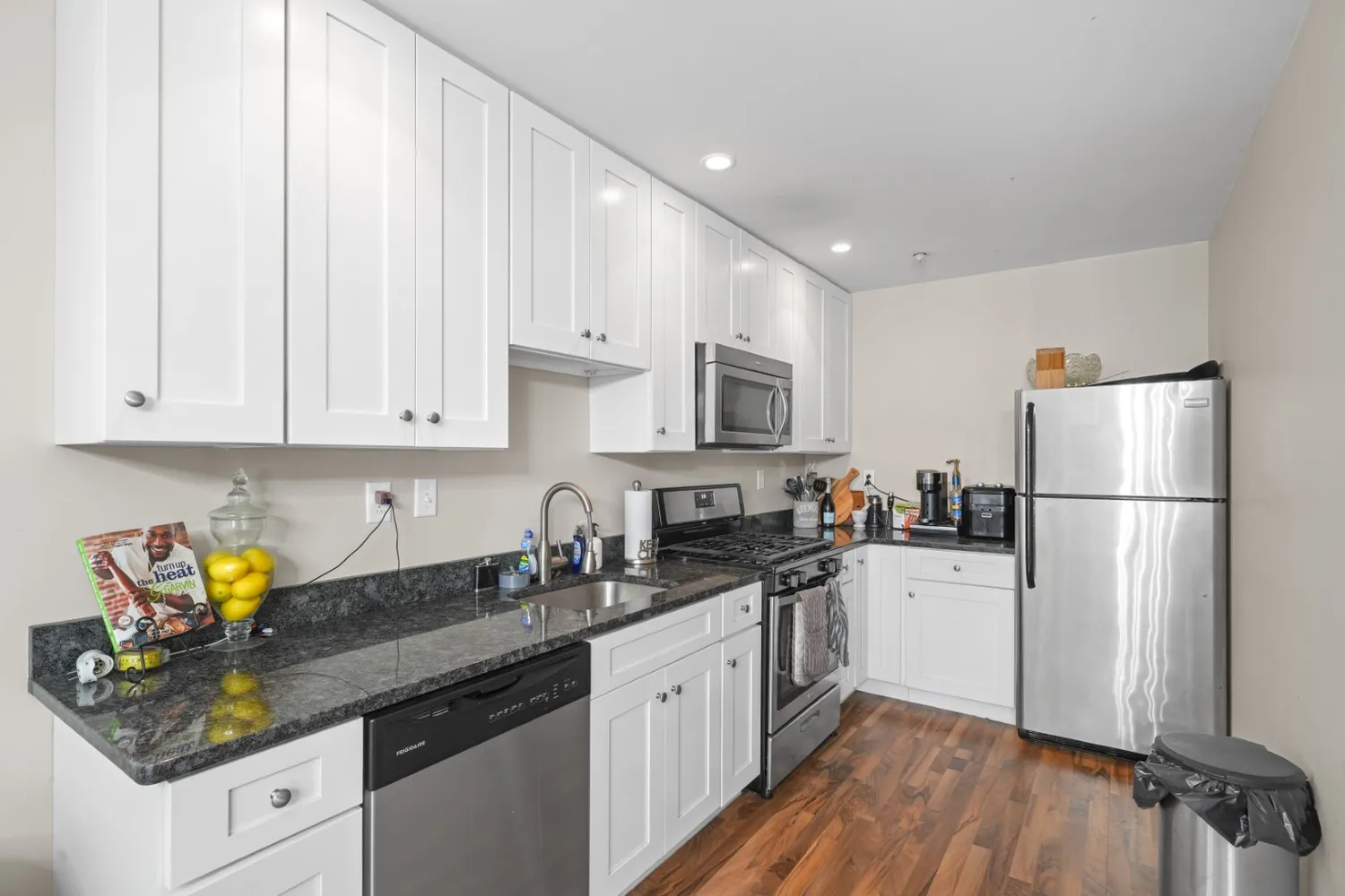 a living room with furniture a fireplace and a chandelier