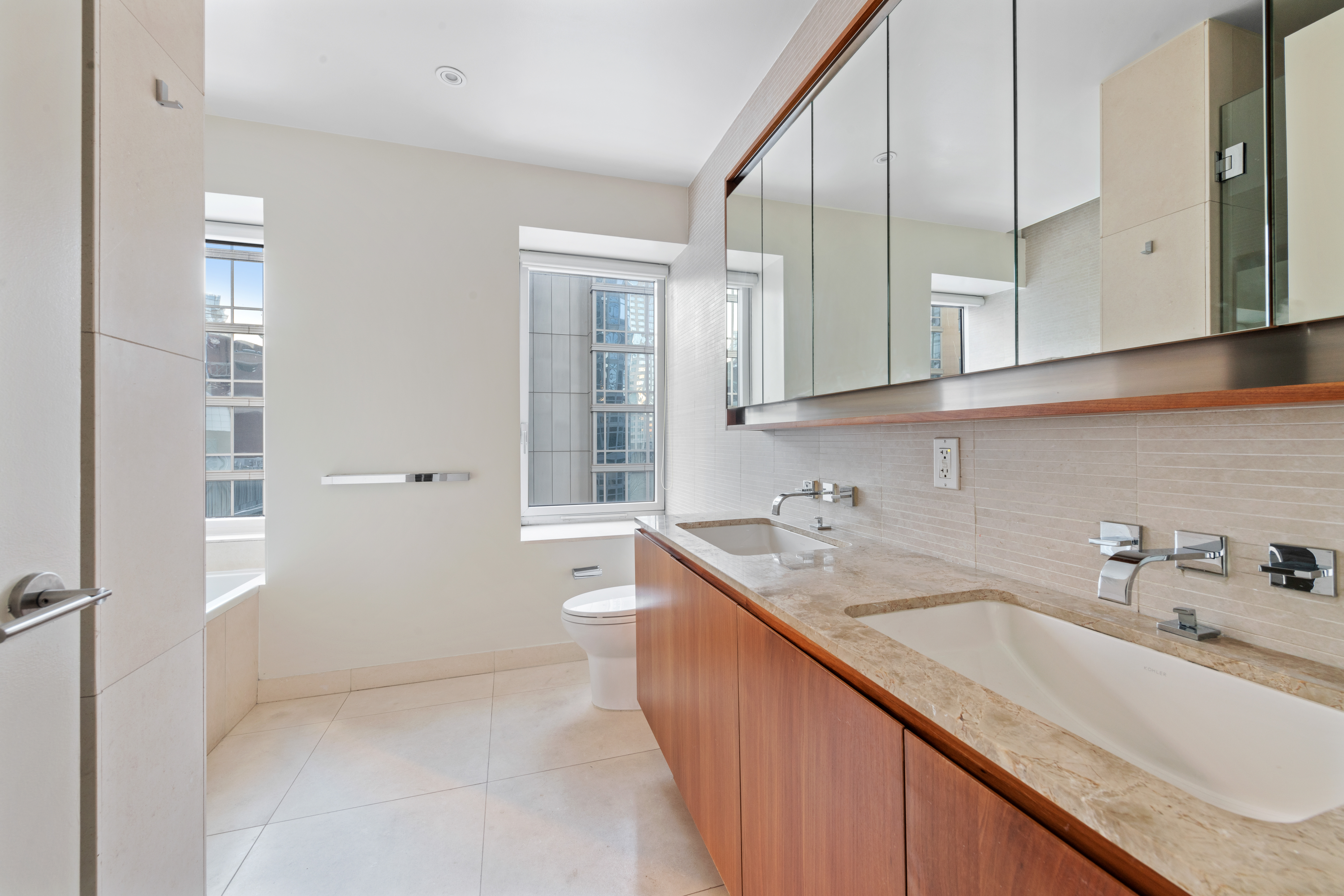 555 West 59th Street, Unit 8B Manhattan, NY 10019 - Photo 8 of 14 a bathroom with a sink a toilet and shower