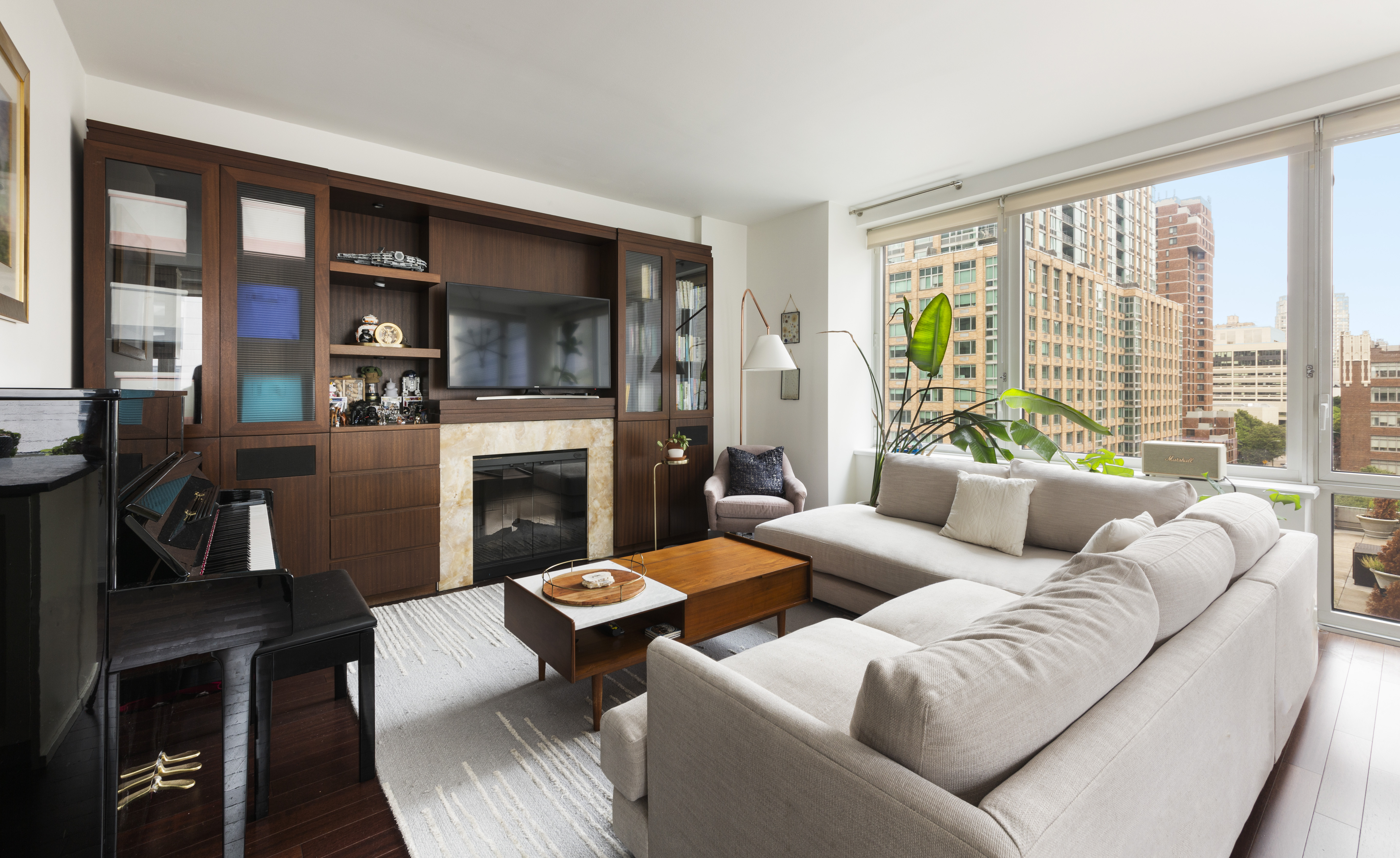 a living room with furniture large window and flat screen tv