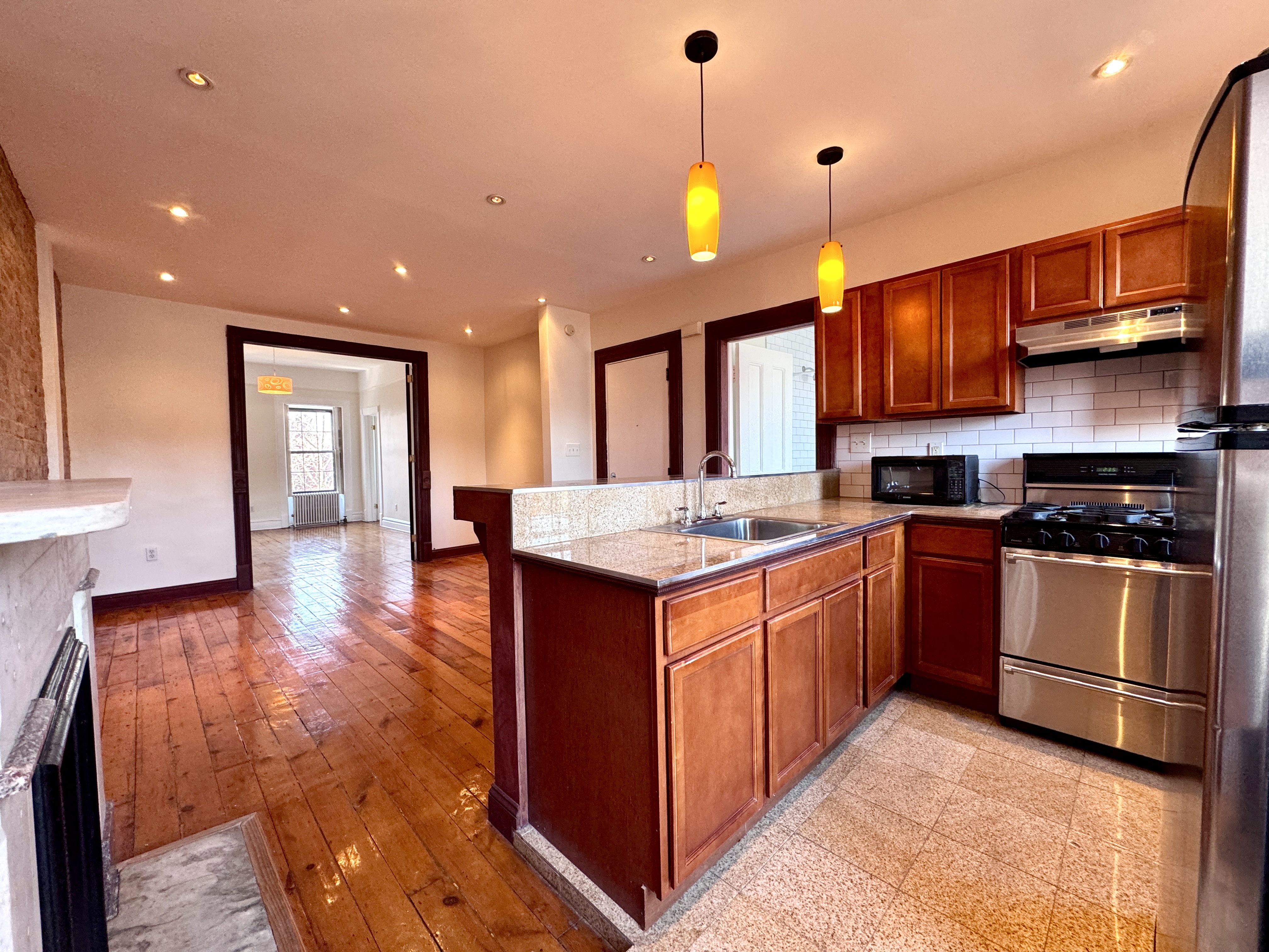15 Arlington Place, Unit 3 Brooklyn, NY 11216 - Photo 6 of 14 a kitchen with stainless steel appliances granite countertop a stove a sink and a refrigerator