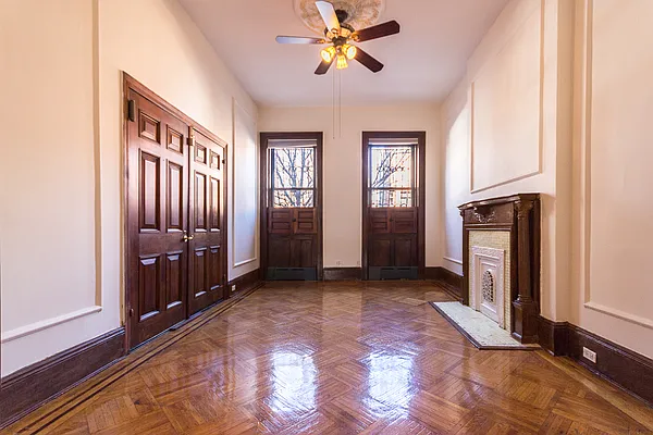 688 Saint Marks Avenue, Unit 1 Brooklyn, NY 11216 - Photo 6 of 10 a view of a hallway with a livingroom with a chandelier fan and windows