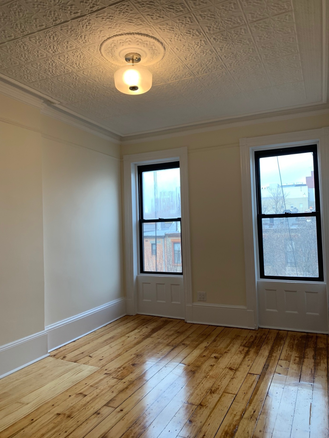 481 9th Street, Unit 4 Brooklyn, NY 11215 - Photo 14 of 33 an empty room with wooden floor and windows