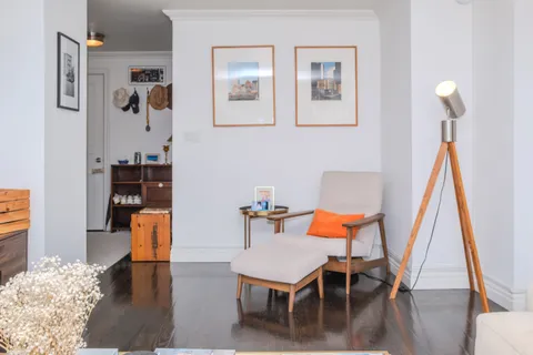 a living room with dining room and wooden floor