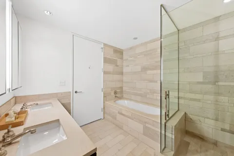 a bathroom with a bathtub and a shower