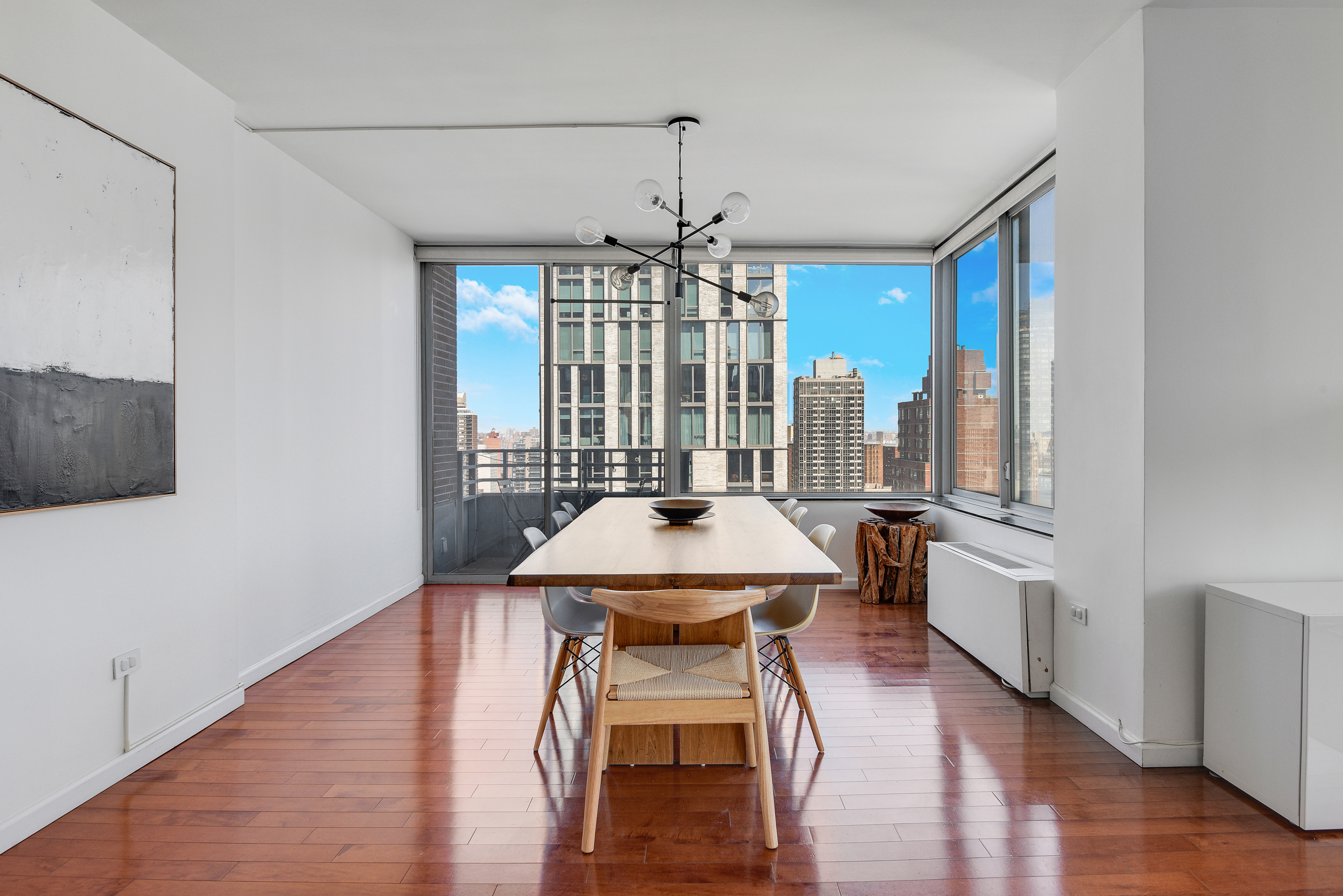 360 East 88th Street, Unit 22C Manhattan, NY 10128 - Photo 8 of 33 a living room with furniture and a chandelier