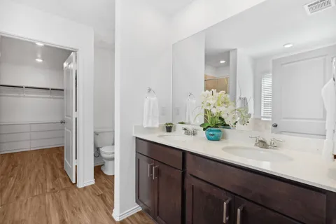 a bathroom with a double vanity sink and mirror