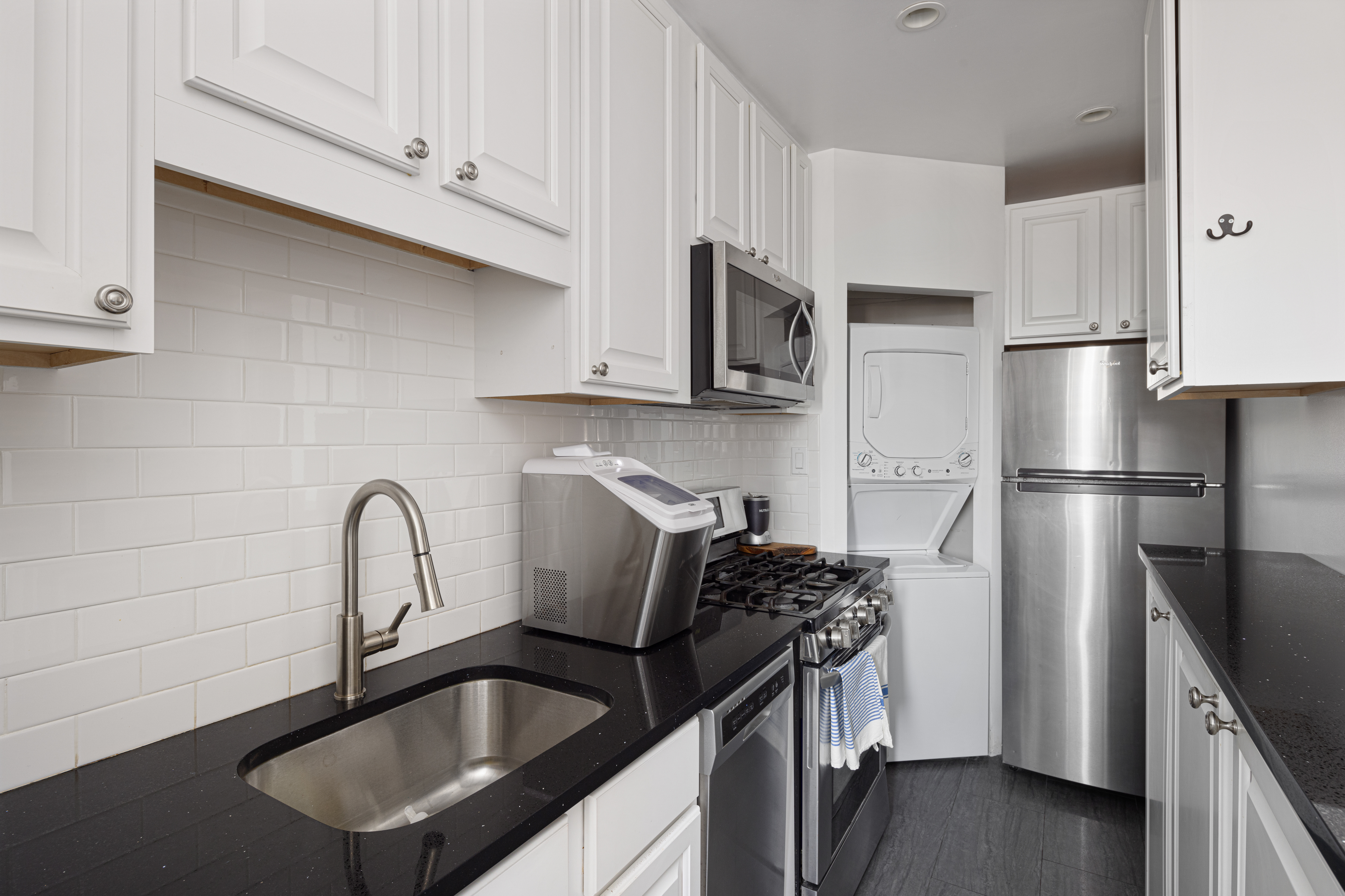 20 Strong Place Brooklyn, NY 11231 - Photo 14 of 21 a kitchen with stainless steel appliances a sink a refrigerator a stove a microwave and cabinets