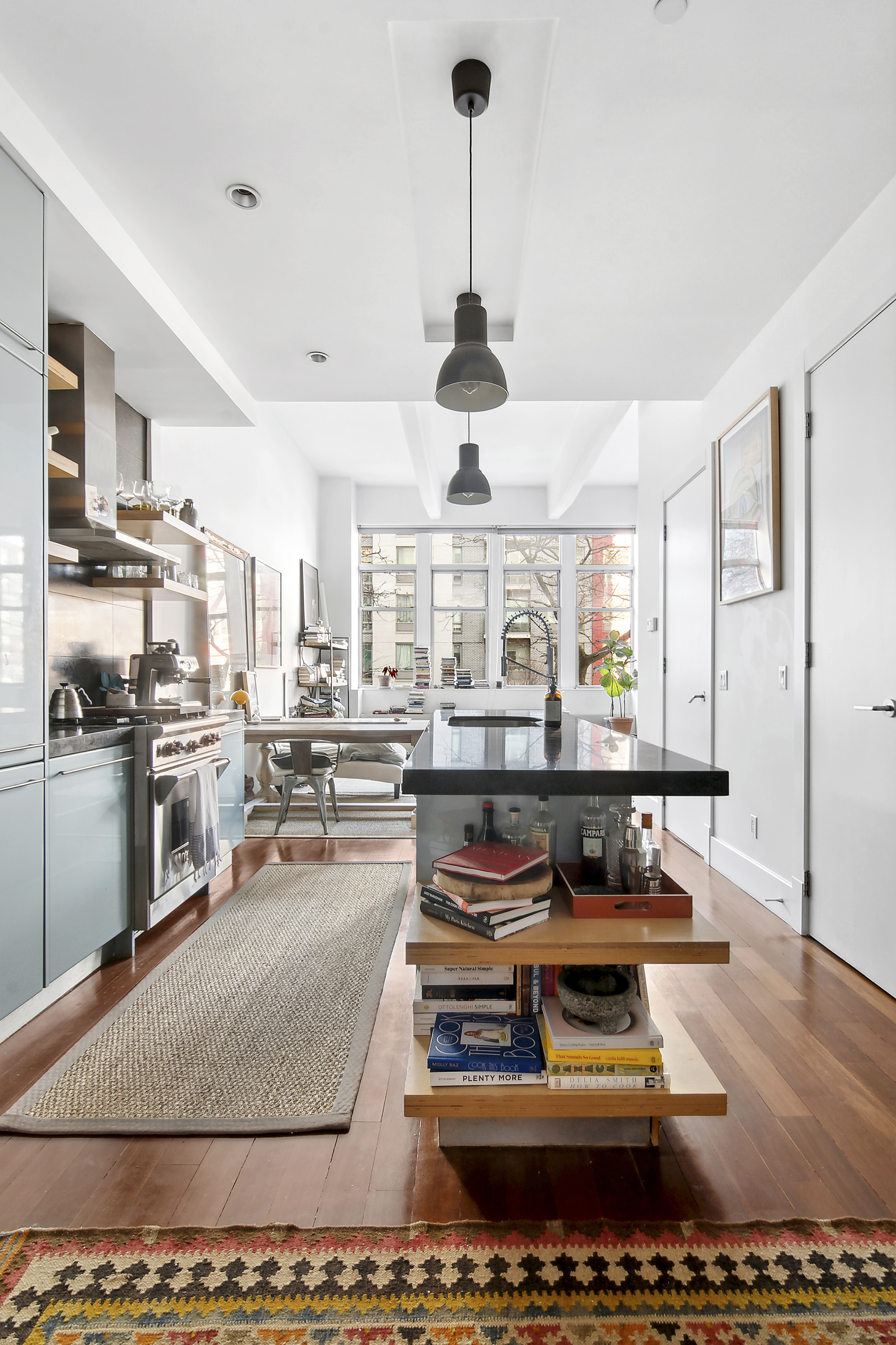 60 Broadway, Unit 2K Brooklyn, NY 11249 - Photo 2 of 7 a kitchen with stainless steel appliances granite countertop a stove and a refrigerator