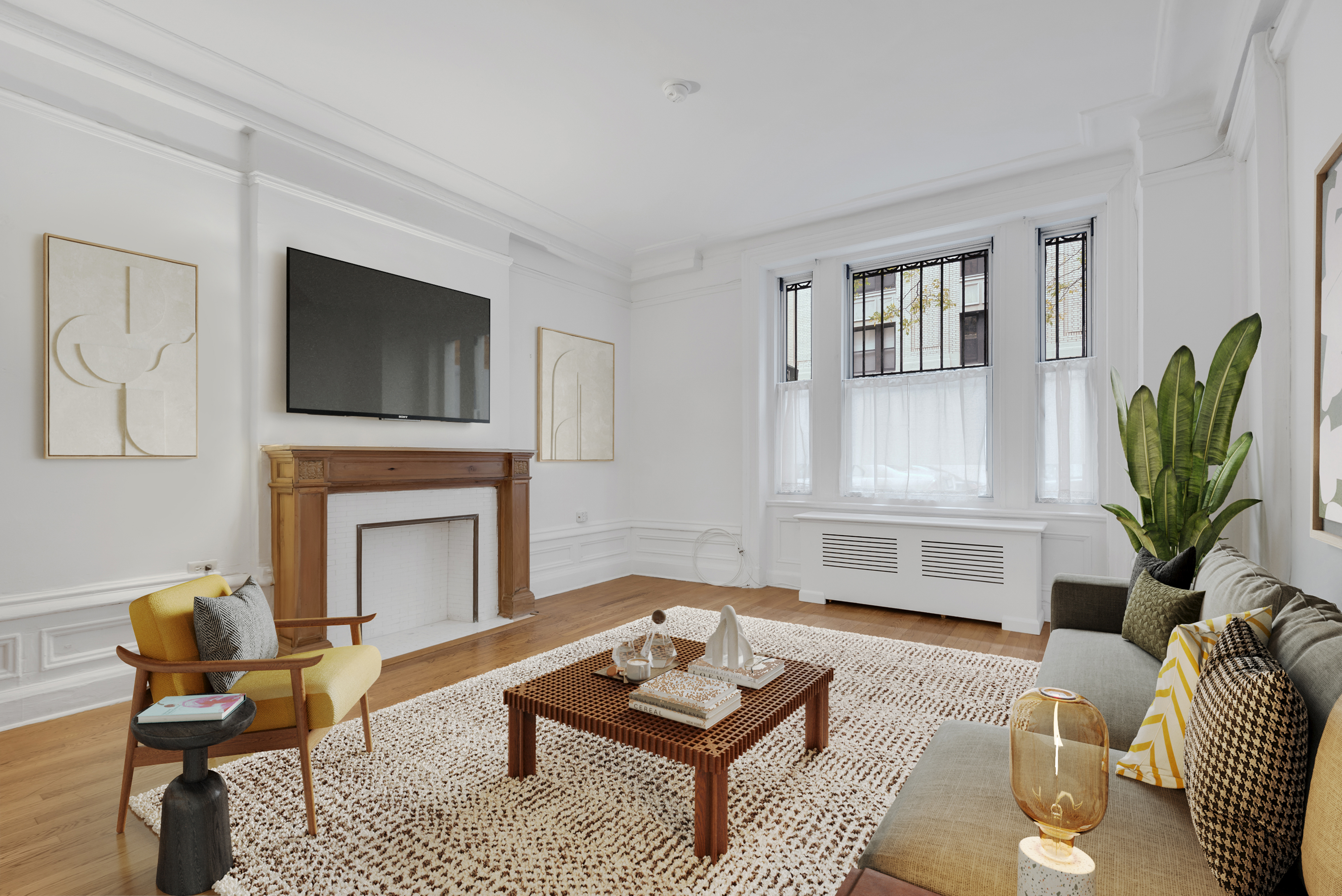 251 West 98th Street, Unit 1B Manhattan, NY 10025 - Photo 1 of 9 a living room with furniture a rug and a fireplace