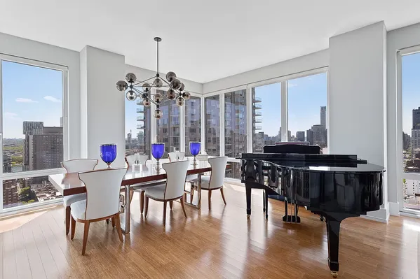 a dining room with furniture window and wooden floor