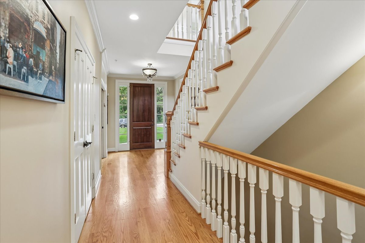 11736 Gainsborough Road Potomac, MD 20854 - Photo 16 of 90 a view of staircase with lots of frames on wall and a window